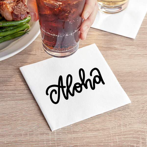 White custom printed Aloha napkin on restaurant table